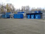 Parking lot with large blue garbage bins